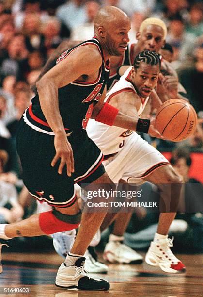 Chicago Bulls Ron Harper heads down-court after stripping the ball from the Philadelphia 76ers Allen Iverson 17 April in Philadelphia. The Bulls won...