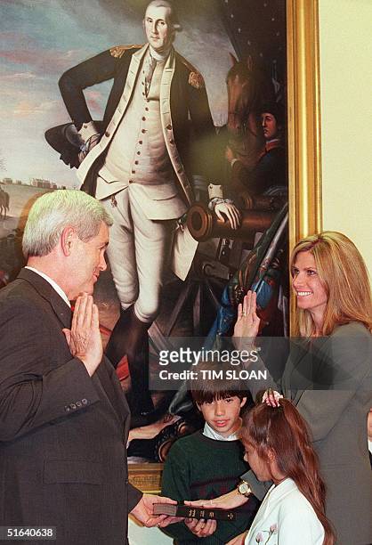 Speaker of the House Newt Gingrich administers the oath of office 21 April to Rep-elect Mary Bono, , R-CA, during a reenactment of her swearing-in...