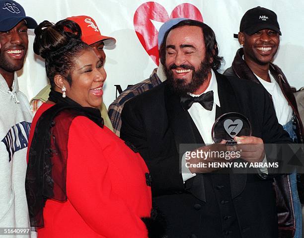 Opera singer Luciano Pavarotti laughs along with singer Aretha Franklin and the group Boyz II Men after accepting the eighth MusiCares Foundation...