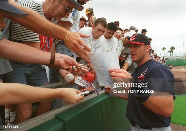 Cleveland Indians infielder Jim Thome signs autographs for fans before the start of a spring training game with the Kansas City Royals at Baseball...