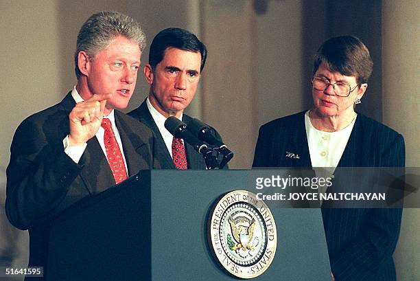President Bill Clinton speaks to an audience as Sen. Charles Robb ,D-VA, and US Attorney General Janet Reno look on 19 March during a school safety...