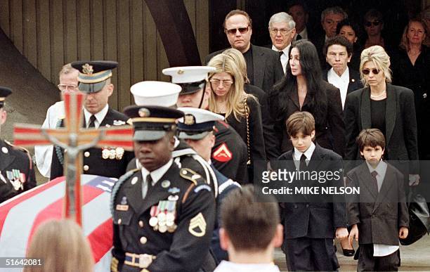 Mary Bono accompanied by Cher and her two children Chesare and Chianna walk behind the casket of her husband Sonny Bono 09 January following a...