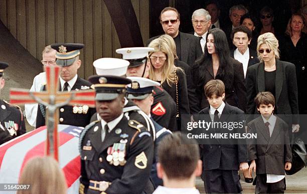 Mary Bono and her son Chesare accompanied by Cher walk behind the casket of her husband Sonny Bono 09 January following a Catholic service in Palm...