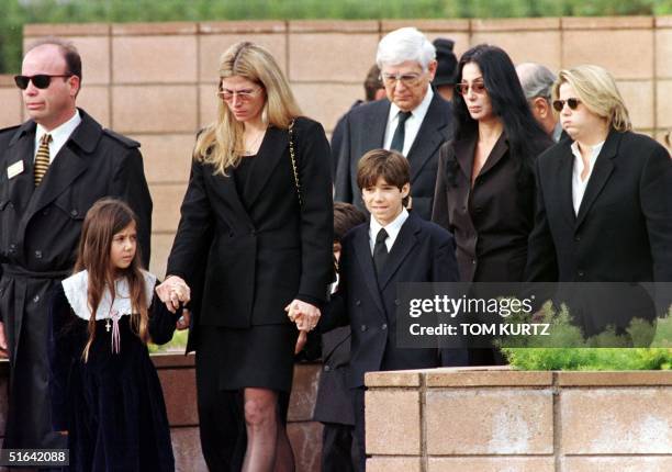 Family members of Sonny Bono walk to the grave site during the burial ceremony for the entertainer and US Congressman at the Desert Memorial Cemetery...