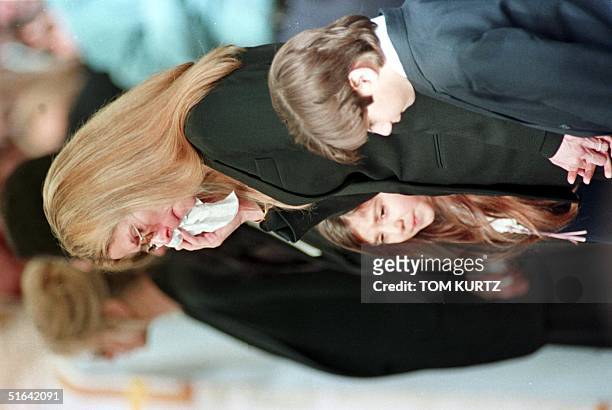 Mary Bono , widow of deceased US Congressman Sonny Bono, wipes her tears during Bonos's funeral 09 January in Cathedral City, CA. She is surrounded...
