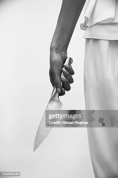 spooky image of knife and woman's hand - kitchen knife foto e immagini stock