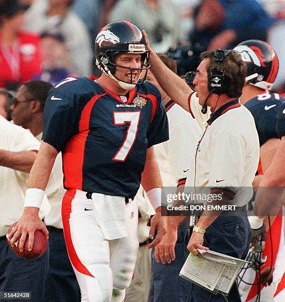 Denver Broncos quarterback John Elway is congratulated by Broncos coach Mike Shanahan after Elway scored a touchdown in the first half of Super Bowl...