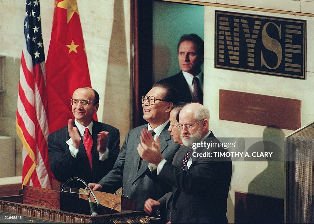 Chinese President Jiang Zemin (2nd-L) rings the o