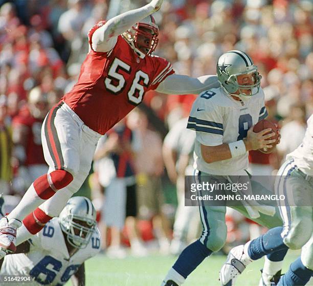 San Francisco 49'ers Chris Doleman sacks Dallas Cowboys quarterback Troy Aikman 02 November in San Francisco. Aikman was sacked four times during the...