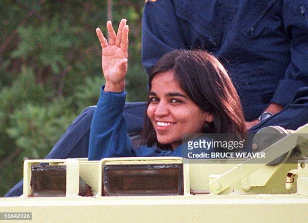 Space shuttle Columbia crewmember Doctor Kalpana Chawla, native of Karnal India, waves to the media 03 November from the drivers seat of an M-113...