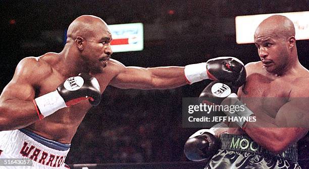 Evander Holyfield punches Michael Moore in the first round of their WBA/IBF Heavyweight Championship Unification fight 08 November at the Thomas &...