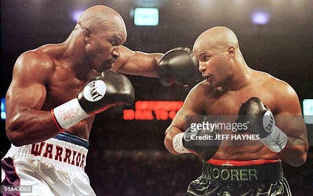 Evander Holyfield lands a left hook on Michael Moorer in the second round of their WBA/IBF Heavyweight Championship Unification fight 08 November in...