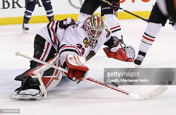 Scott Darling of the Chicago Blackhawks blocks a shot on goal in second-period action in an NHL game against the Winnipeg Jets at the MTS Centre on...