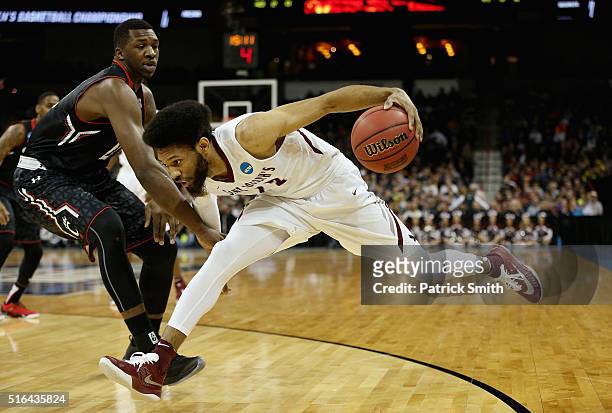 DeAndre Bembry of the Saint Joseph's Hawks drives against Coreontae DeBerry Cincinnati Bearcats in the first half during the first round of the 2016...