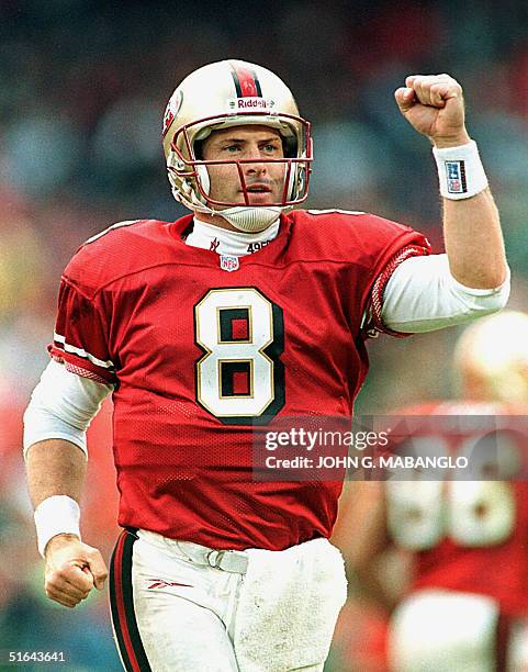 San Francisco 49ers quarterback Steve Young celebrates after throwing a touchdown pass to wide receiver Terrell Owens during their game with the...