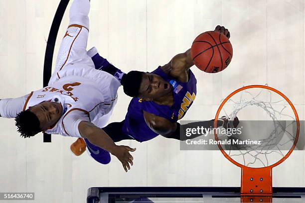 Wes Washpun of the Northern Iowa Panthers shoots the ball in the first half against Demarcus Holland of the Texas Longhorns during the first round of...