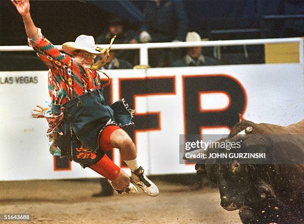 Rodeo clown Ray Wiley is tossed into the air after being hit by the Bull "Ice Pick" during the 5th go-round of the Bull Fighting Event at the...