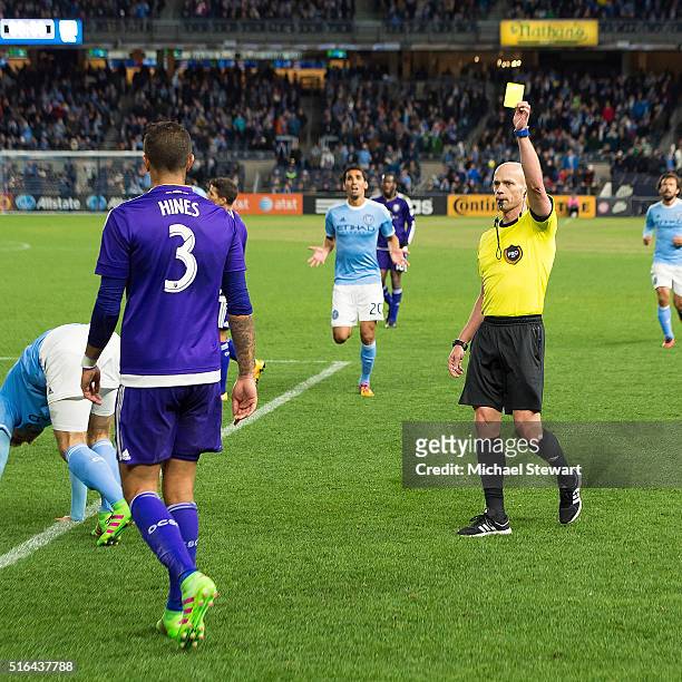 Defender Seb Hines of Orlando City SC receives a yellow card during the Orlando City SC vs New York City FC match at Yankee Stadium on March 18, 2016...