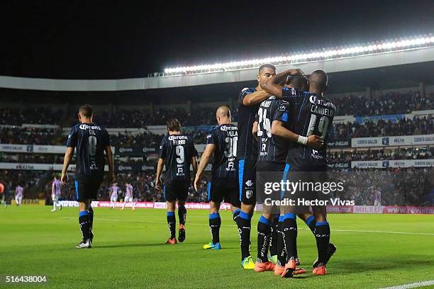 Edgar Benitez of Queretaro celebrates with teammates after scoring the first goal of his team during the 11th round match between Queretaro and...