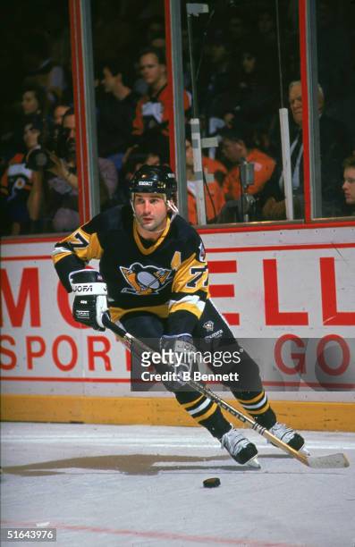 Canadian professional hockey player and 2004 Hall of Fame inductee defenseman Paul Coffey of the Pittsburgh Penguins skates on the ice with the puck...