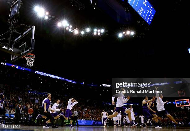 The Northern Iowa Panthers bench celebrates after Paul Jesperson of the Northern Iowa Panthers hit a half court three pointer at the buzzer to defeat...