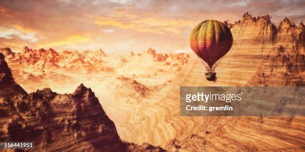 steampunk hot air ballon flying over fantasy canyon landscape - be boundless summit stock pictures, royalty-free photos & images