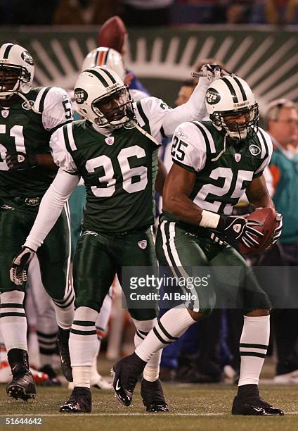 David Barrett congratulates teammate Reggie Tongue of the New York Jets after Tongue recovered a fumble by Donald Lee of the Miami Dolphins during...