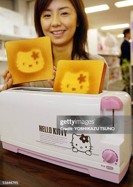 Japanese character goods maker Sanrio employee displays a Hello Kitty designed toaster, produced by Japanese electronic maker Twinbird to celebrate...
