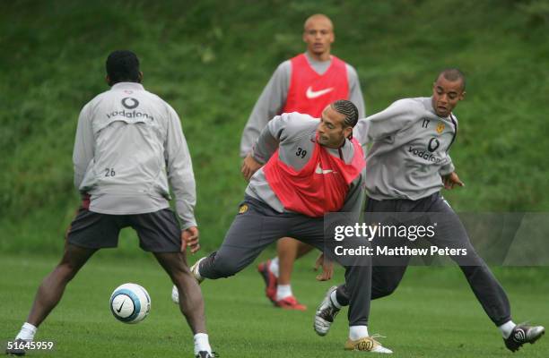 Rio Ferdinand and David Bellion of Manchester United in action during a first team training session ahead of the UEFA Champions League match against...