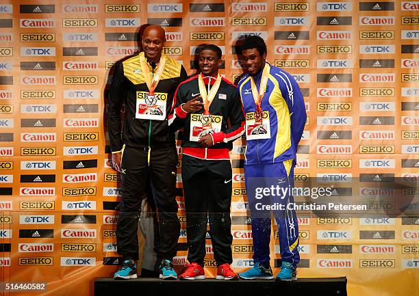 Silver medallist Asafa Powell of Jamaica, gold medallist Trayvon Bromell of the United States and bronze medallist Ramon Gittens of Barbados pose on...