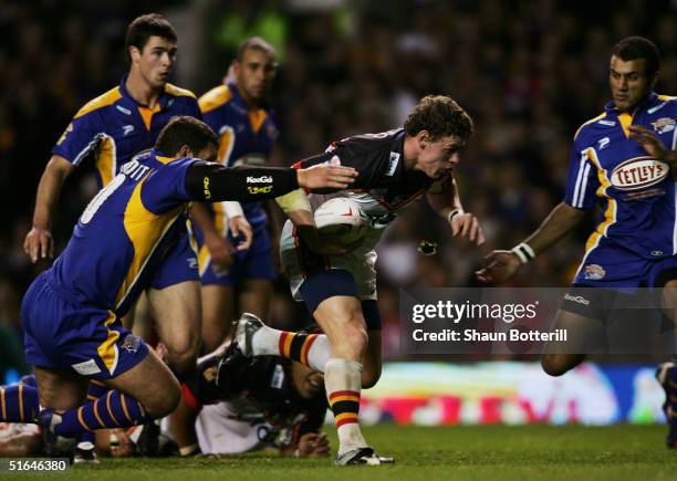 Bradford's Lee Radford is tackled by Barry McDermott of Leeds during the Tetley's Super League Grand Final between Bradford Bulls and Leeds Rhinos at...