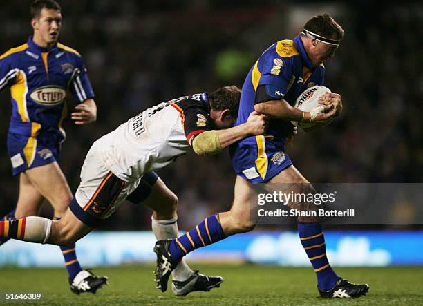 David Furner of Leeds is tackled by Bradford's Lee Radford during the Tetley's Super League Grand Final between Bradford Bulls and Leeds Rhinos at...