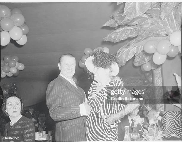 Mrs. Frank Henderson, Bette, with John Perona, owner of the El Morocco Nightclub, 154 East 54th Street, New York City.