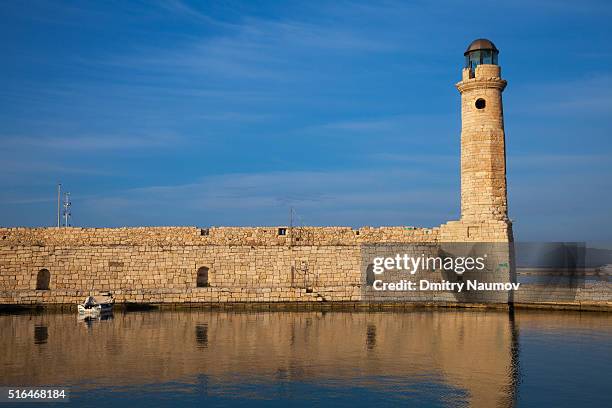 lighthouse and wall at old venetian harbour in rethymno (rethymnon), island of crete, greece, mediterranean - rethymnon town stock-fotos und bilder