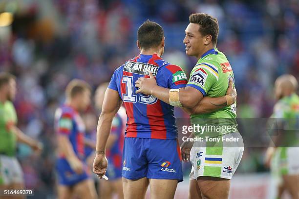 Josh Papalii of the Raiders hugs Sione Mata'Utia of the Knights after game finished in a draw during the round three NRL match between the Newcastle...