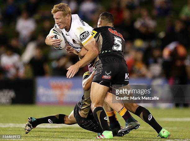 Jack Reed of the Broncos is tackled by Dallin Watene-Zelezniak of the Panthers during the round three NRL match between the Penrith Panthers and the...