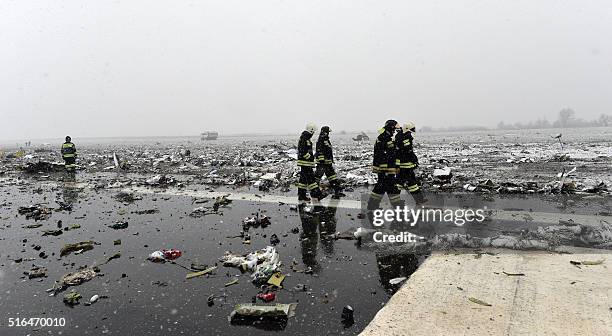 Russian emergency rescuers work on the wreckage of the flydubai passenger jet which crashed, killing all 62 people on board as it tried to land in...