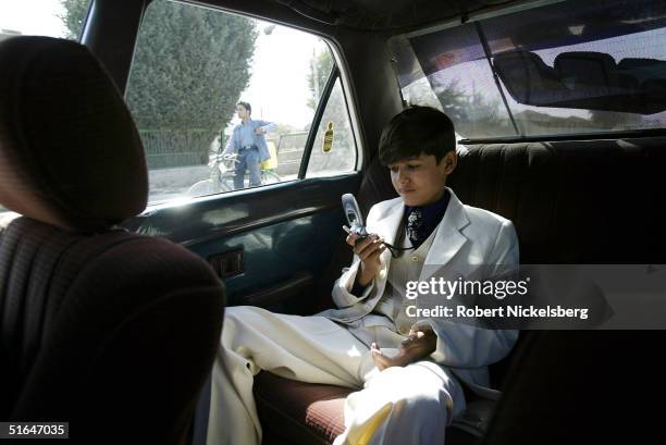 Afghan singer Mirwais Najrabi rides in a friend's car September 29, 2004 in Kabul, Afghanistan. He is dressed to perform at a live weekly Kabul...
