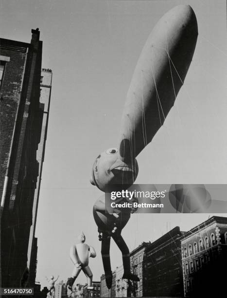 Pinocchio balloon, followed by Tin Man and trapeze artist balloons in Macy's Thanksgiving Day Parade in New York City, 23rd November 1939.