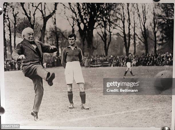 David Lloyd George , British Prime Minister 1916-22, shown kicking off in the Semi-Final for the Welsch Amateur Football Cup. Undated photograph,...