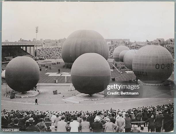 Brussels, Belgium: King Leopold III assists Professor Picard and Cosyns as they prepare to rise to the stratosphere in their hot air balloons at the...