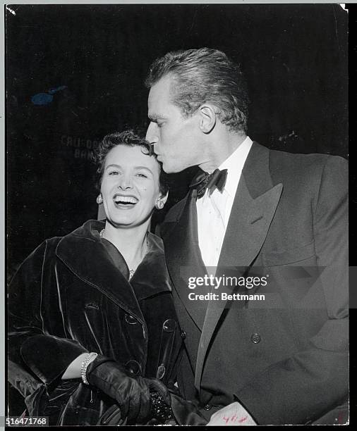 Hollywod, CA- It's love... Charlton Heston, still in love with his wife, Lydia, kisses her affectionately before entering the auditorium to attend a...