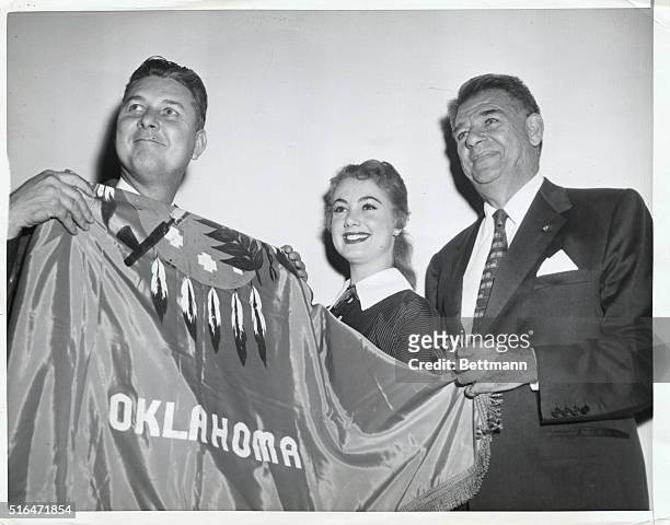 Oklahoma Governor Raymond Gary pays a visit to the set of the motion picture version of "Oklahoma." With him are Oscar Hammerstein, who wrote the...