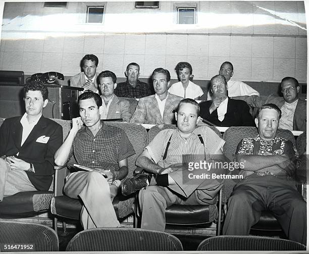 In the projection room, Ida Lupino, surrounded by her staff and members of the cast, watch one day's output on the screen of her latest picture,...