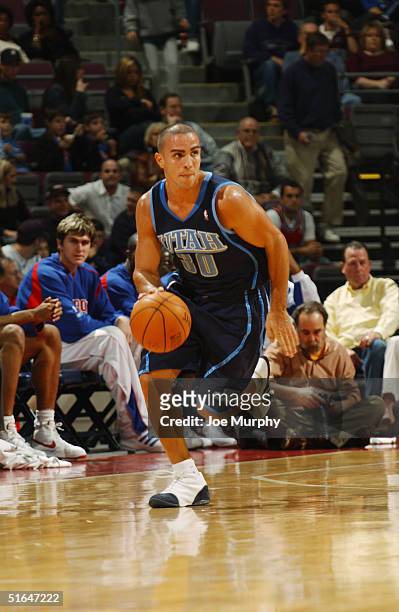 Carlos Arroyo of the Utah Jazz moves the ball during the preseason game with the Detroit Pistons at The Palace of Auburn Hills on October 24, 2004 in...