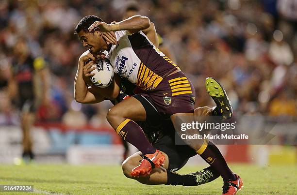 Anthony Milford of the Broncos is tackled as he scores a try during the round three NRL match between the Penrith Panthers and the Brisbane Broncos...