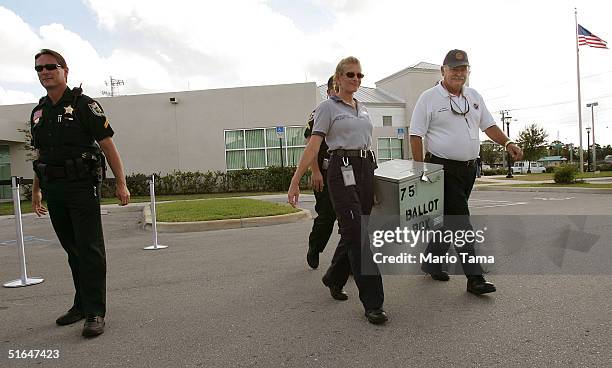 Worker carry a ballot box out of Palm Beach County Supervisor of Elections headquarters November 2, 2004 in West Palm Beach, Florida. Polls showed...