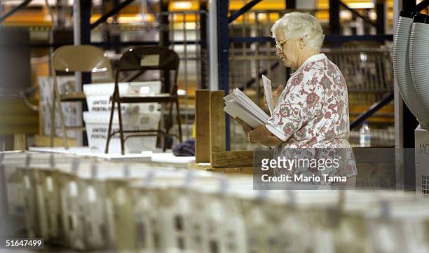Worker sorts absentee ballots at Palm Beach County Supervisor of Elections headquarters November 2, 2004 in West Palm Beach, Florida. Polls showed...