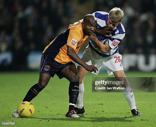 Barry Hayles of Millwall holds off Frankie Simek of QPR during the Coca Cola Football League Championship match between Queens Park Rangers and...