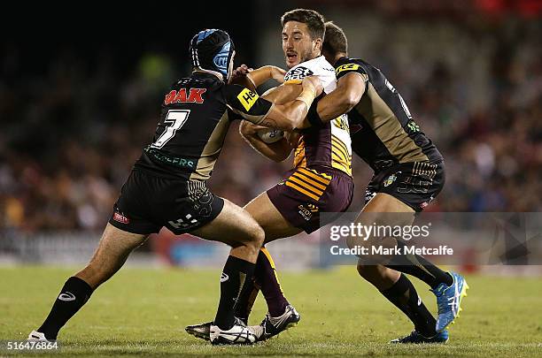 Ben Hunt of the Broncos is tackled by Jamie Soward of the Panthers during the round three NRL match between the Penrith Panthers and the Brisbane...